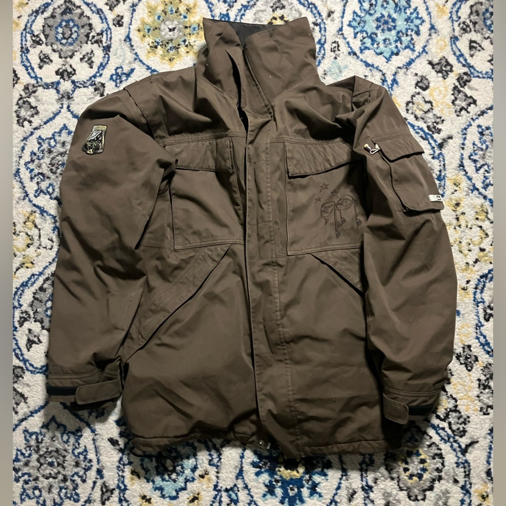 Brown quicksilver ski jacket with embroidery and patch.